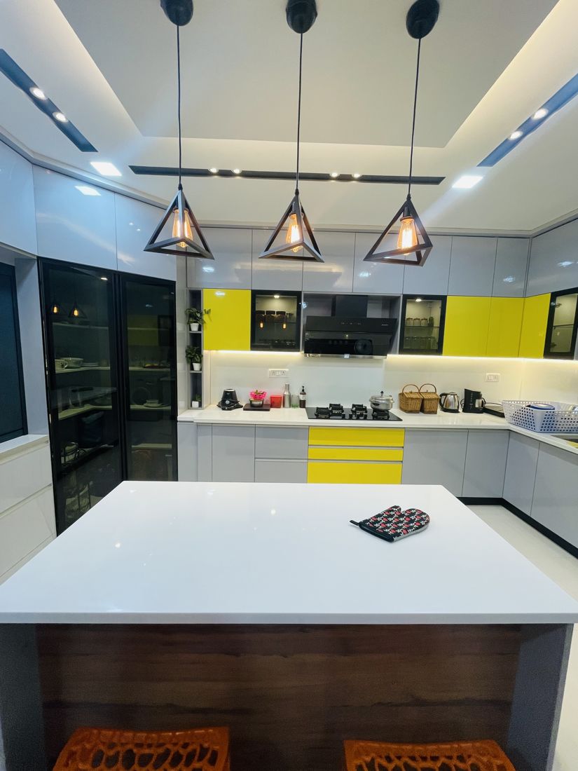 Bright island kitchen with yellow accents from a real Dreamcraft Interiors home in Chennai
